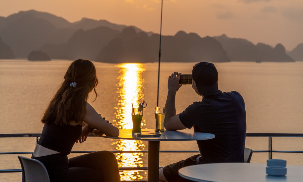 Guests enjoying sunset over Halong Bay