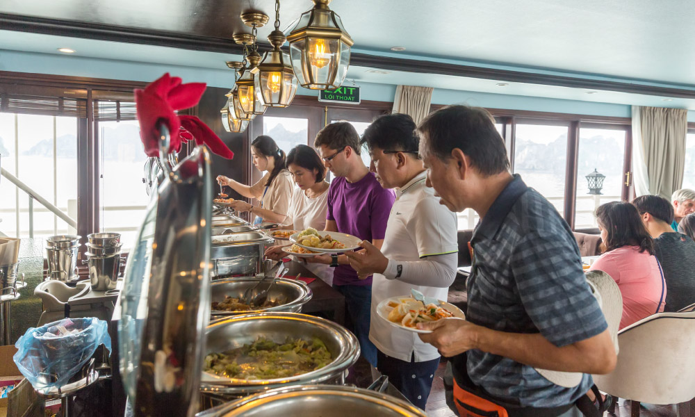 Athena cruise visitors taking food from the buffet station.