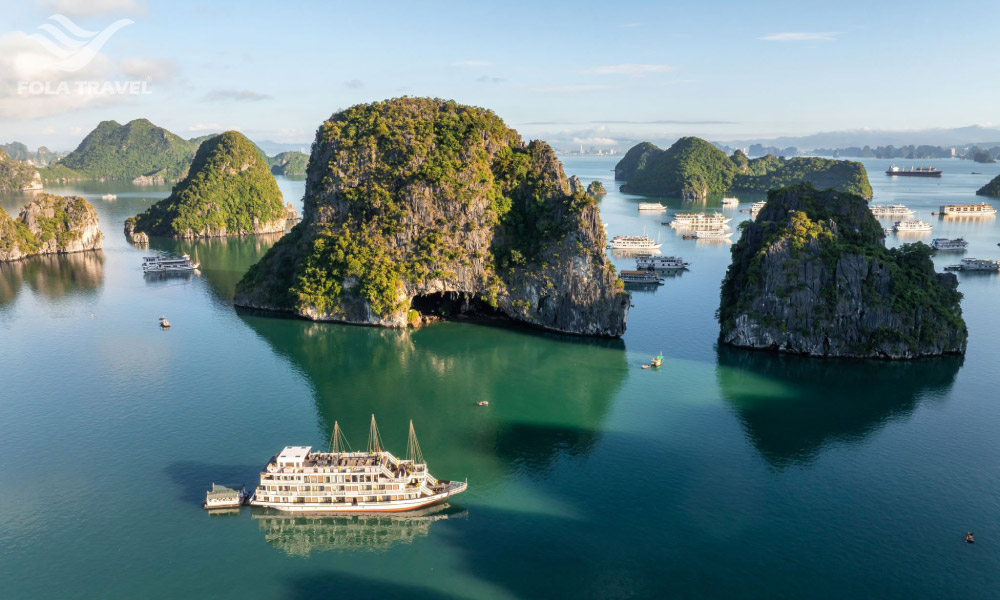 Halong panorama in spring with islands and some cruises among them.