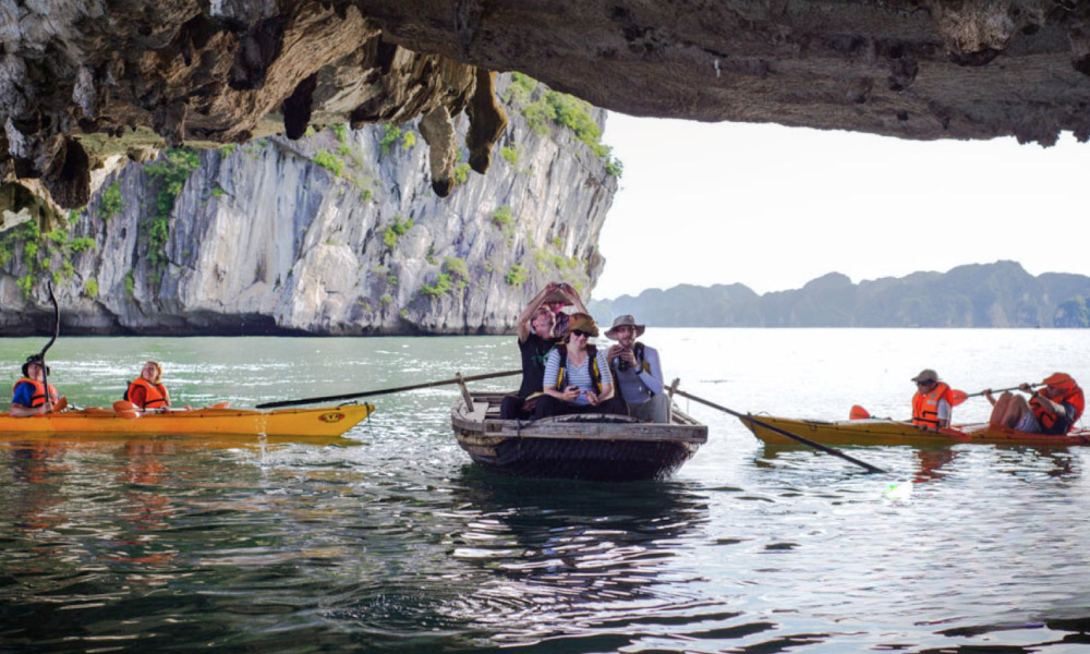 Two kayaks and onw bamboo boat under Luon Cave.