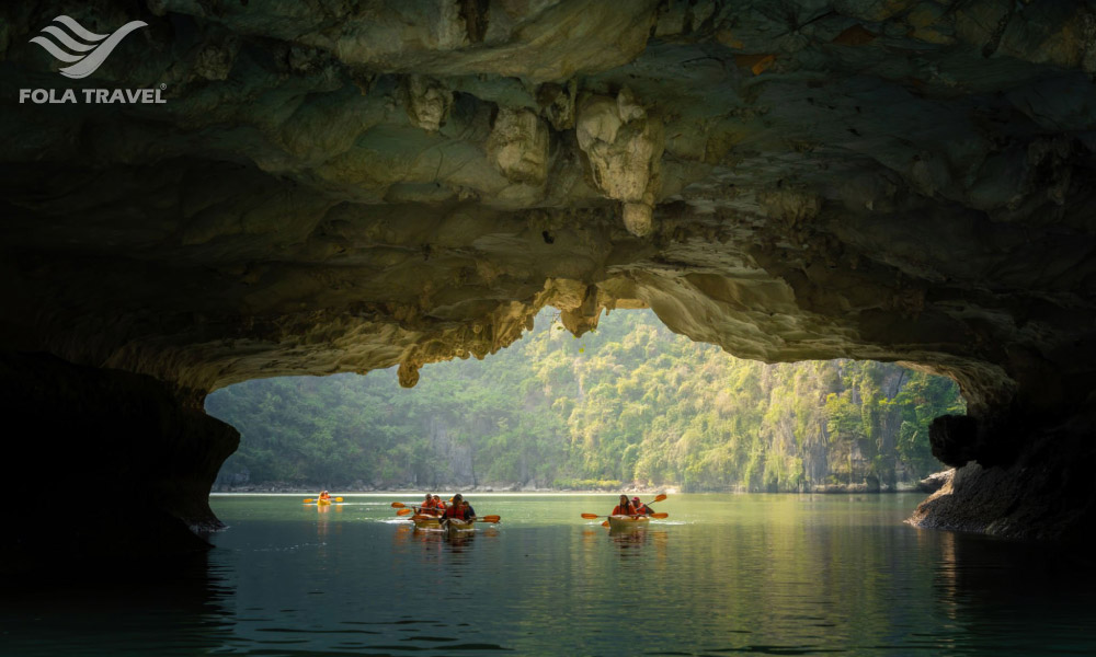 Kayaking through a cave in Halong Bay.