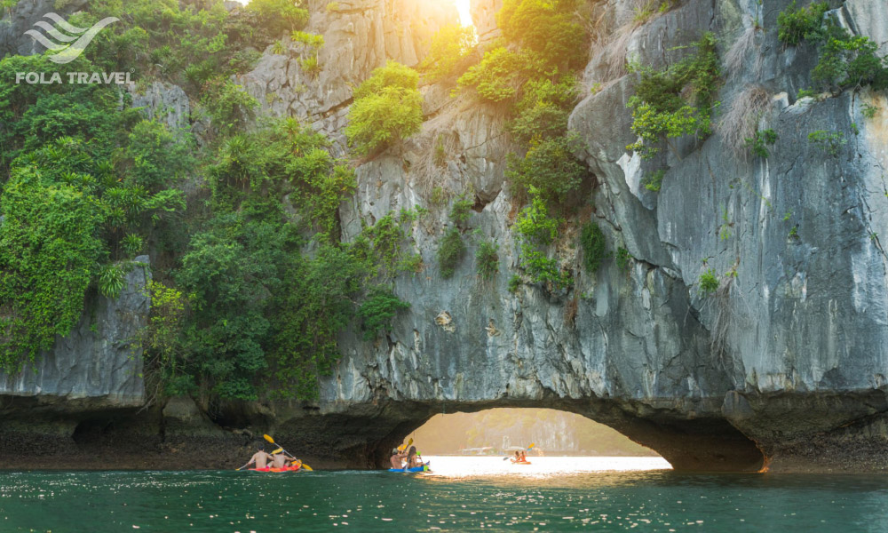 Halong Cave with people on kayaks going through it.