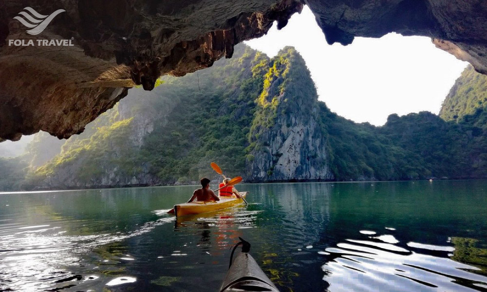 A kayak getting out of Luon Cave with islands in front of it.