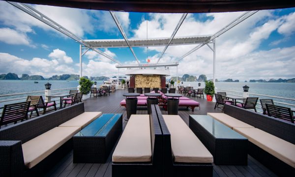 The sundeck on Athena Luxury cruise with many lounge chairs and a bar in the middle.