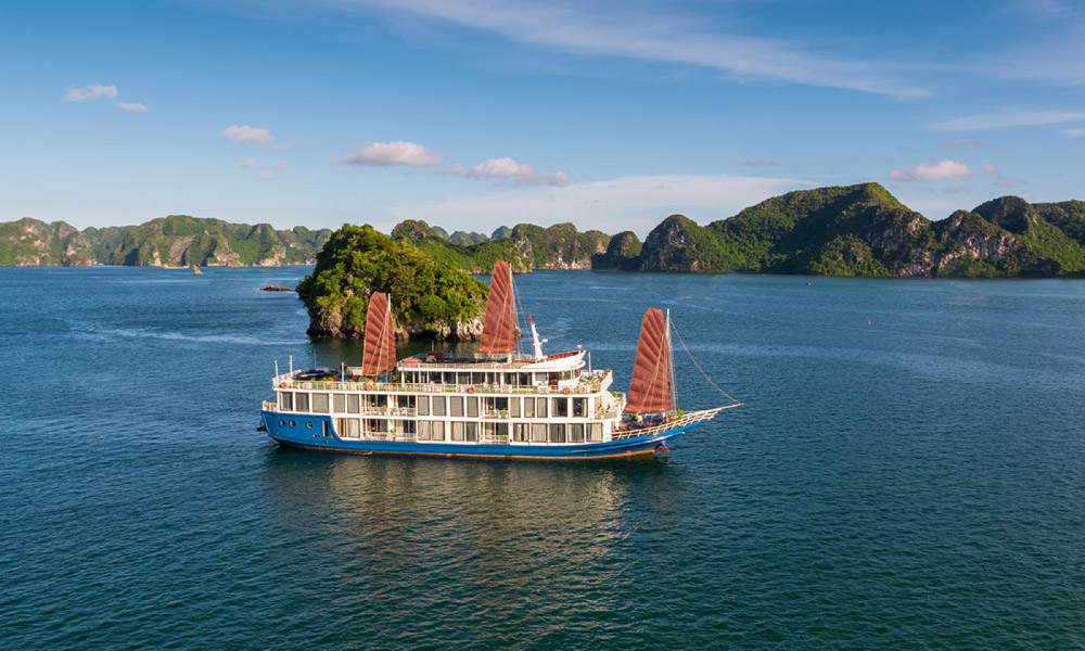 Panorama of Halong Bay with Verdure Lotus Classic Cruise in the middle.