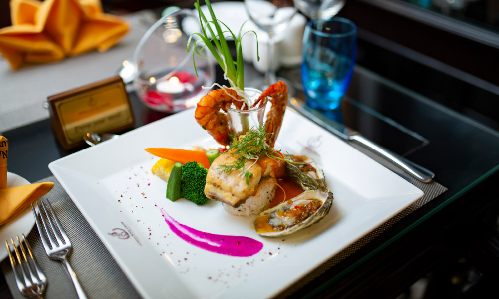 A plate of seafood with two shrimps making a heart.