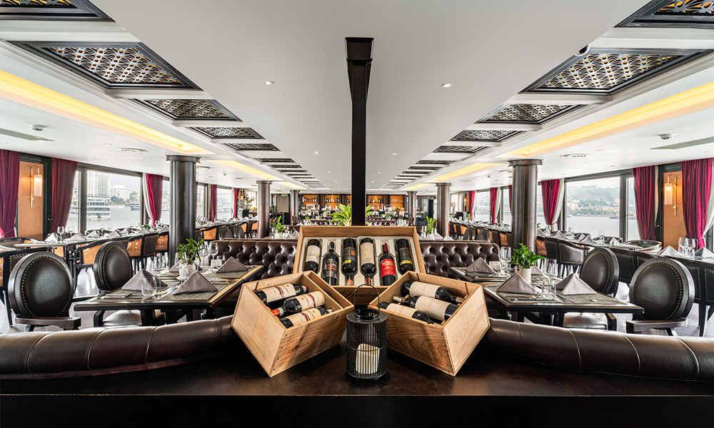 The restaurant on Ambassador 1 Cruise looking from behind a counter with some wine boxes.