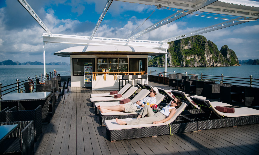 Athena luxury sundeck with two rows of white lounge chairs.