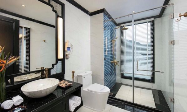 The verdure lotus luxury cruise with Halong Bay islands behind.