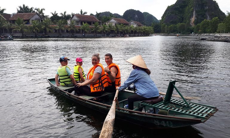 Close up of guests on a Trang An bamboo boat.