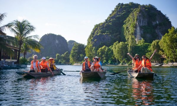 Three bamboo boats with six guests in the middle of Trang An.