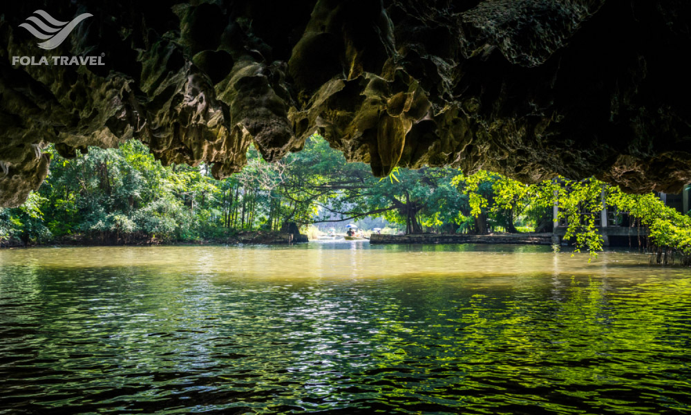 A water cave with ceiling of limestone and floor of water in Ninh Binh.