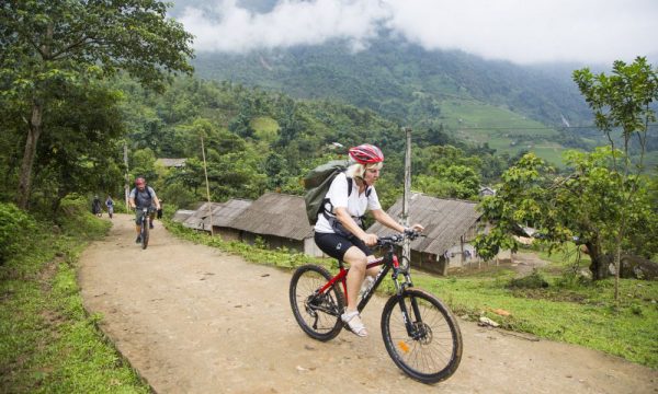 Tourists biking around the village in Sapa.