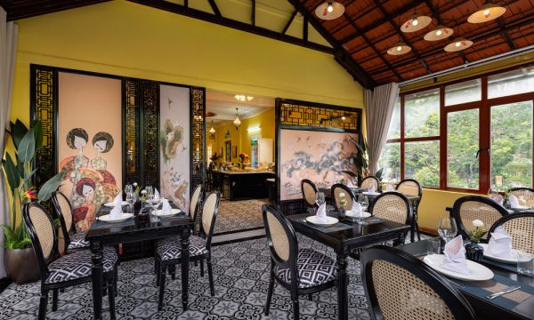 Open restaurant space with black tables and chairs.