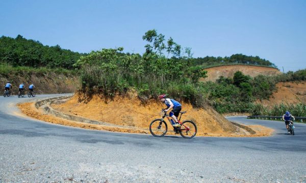 People cycling around the slope trails in Sapa.