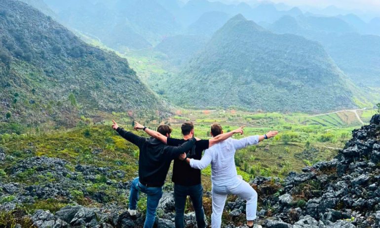 Three men in front of Ha Giang valley.