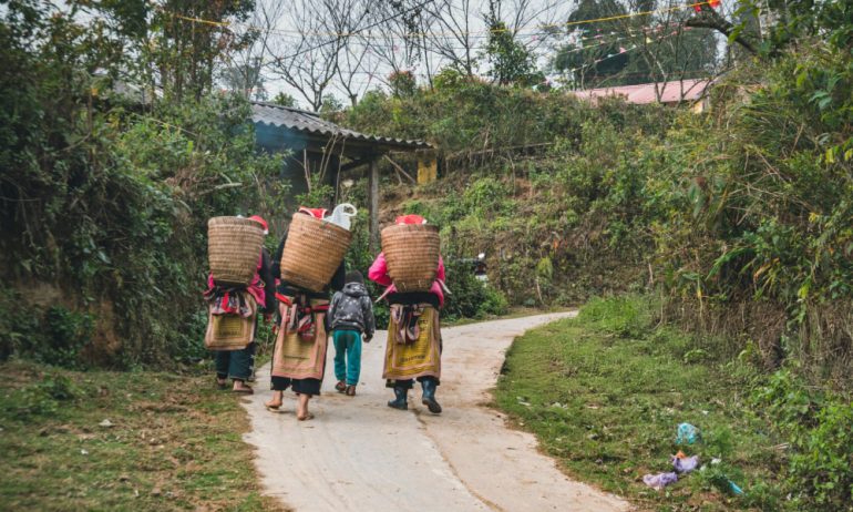 Ethnic woman and a child on a trail in a village.