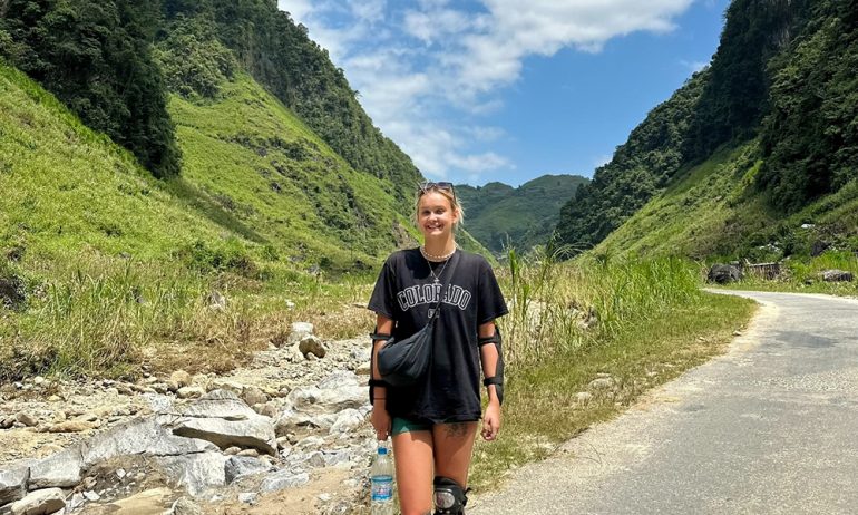 A girl on a trail in the middle of Ha Giang mountains.