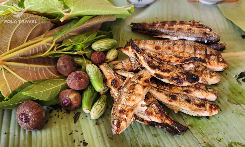 Small grilled fish and some local fruits.