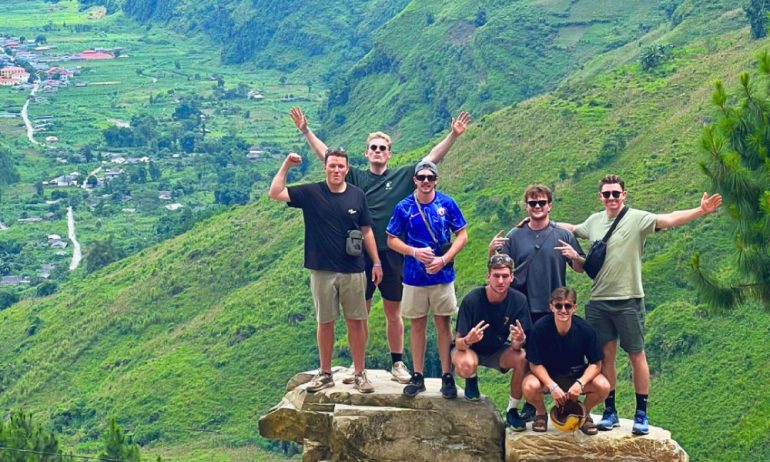 Guests of Ha Giang Loop in front of a valley.