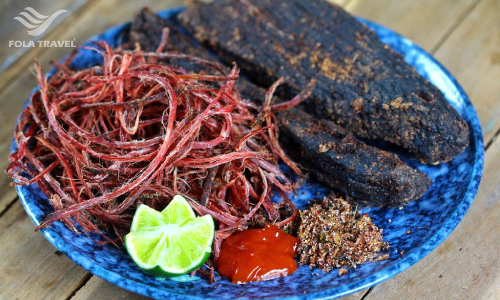 A plate of dried buffalo meat and sauces.