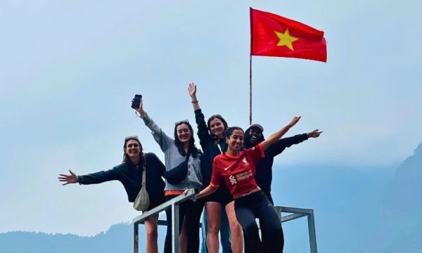 Guests in Ha Giang with Vietnam flag.