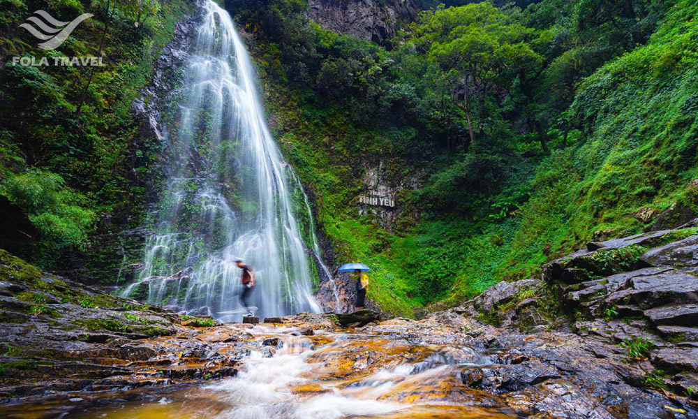 Two people under Love waterfall.