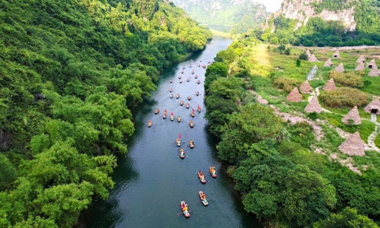 Many boats on Ngo Dong river between Trang An mountains.