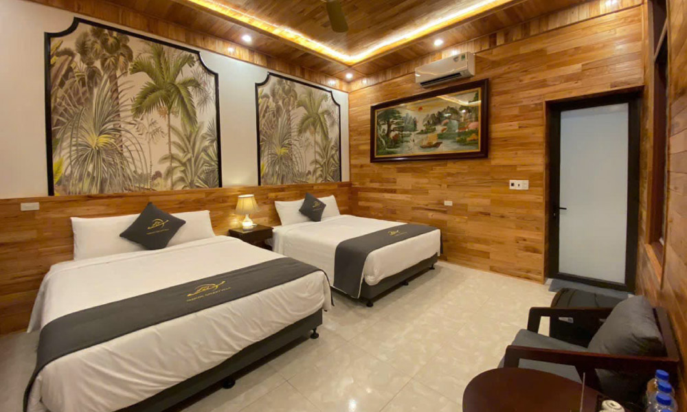 A bungalow with wooden walls and ceiling and two beds.