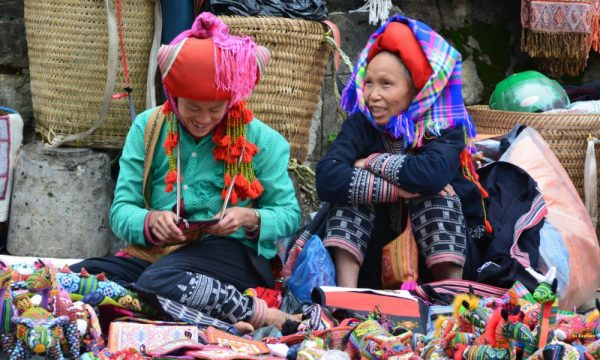 Two women smiling in a Sapa market.