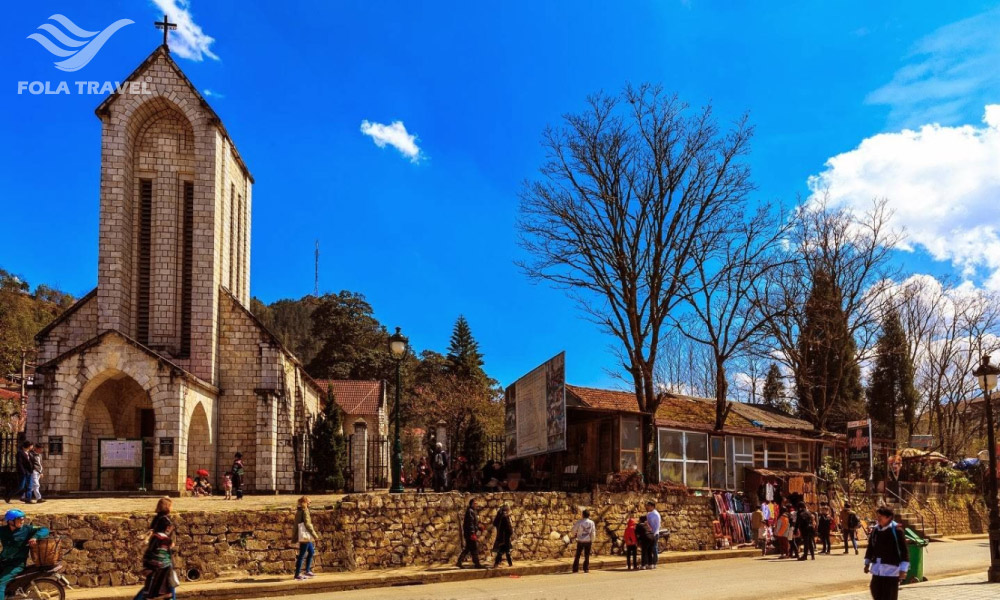 Stone church with people going around.