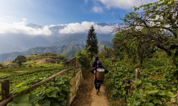 Ethnic people walking in the middle of Sapa village.