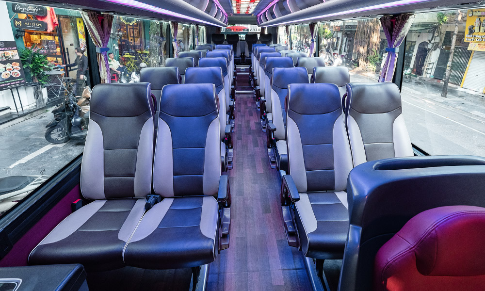 Inside a shuttle bus with two rows of chairs.