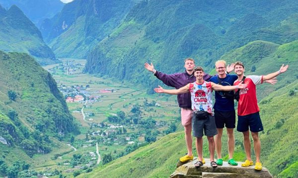 Four men in front of a Ha Giang valley.