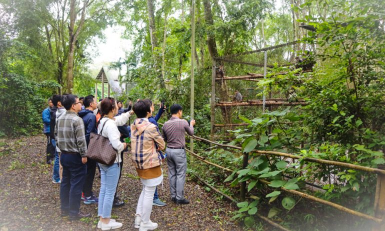 Ninh Binh visitors watching animals in Cuc Phuong National Park.