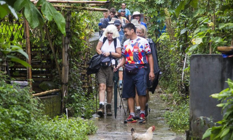 Tourists trekking in Sapa village.