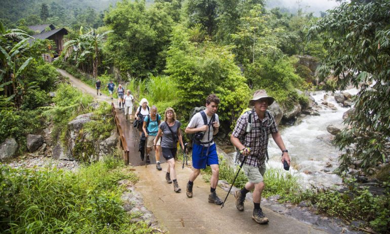 Tourists walking through a village in Sapa.