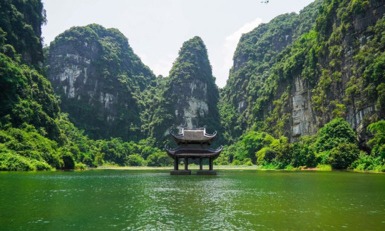 A pagoda in the middle of Trang An mountains and river.