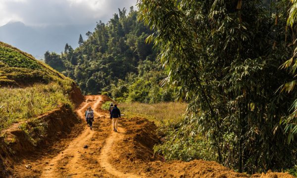 Tourists trekking on dirt trails in Sapa.