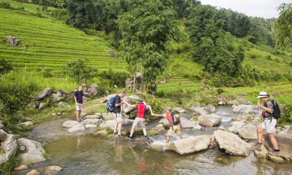 Tourists going through a stream in Sapa.