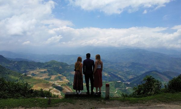 Three people stading in front of Ha Giang panorama.