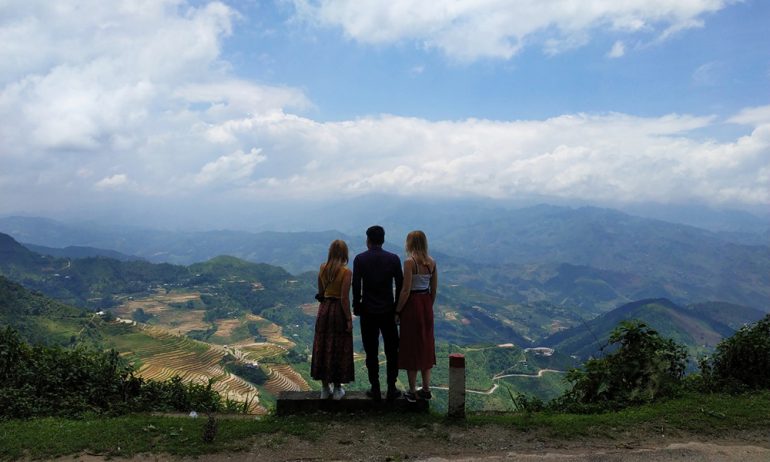 Three people stading in front of Ha Giang panorama.