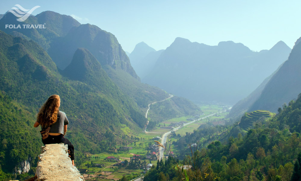 A girl on a rock looking down to Sung La valley.