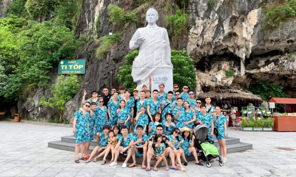 Guests under Titov statue.