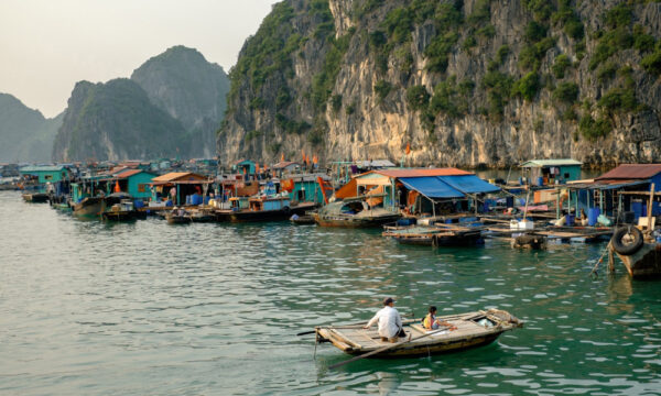 Bamboo boat ride through Cai Beo houses.