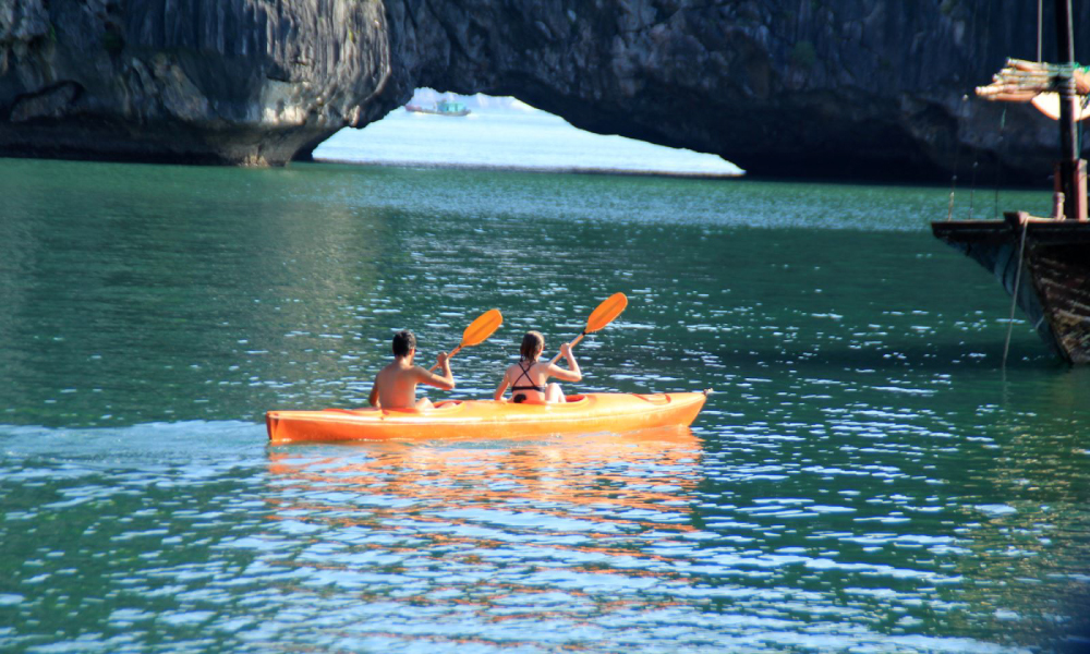 Two people kayak in the bay.