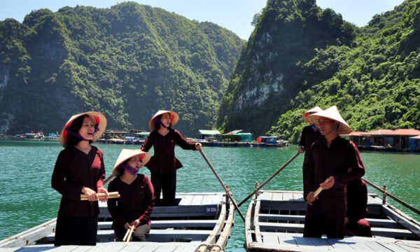 Local singers of Cua Van Fishing Village perform on boats.
