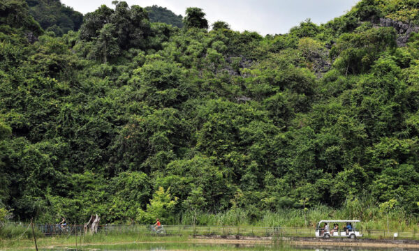 Cycling under Viet Hai mountains.