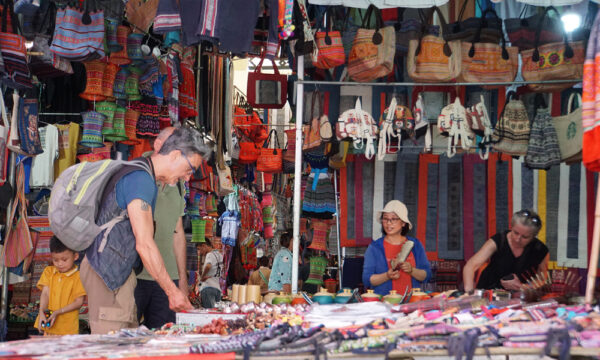 Foreign guests visiting Bac Ha Market and choosing products.