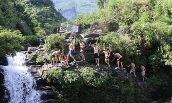 Guests line up to jump at Du Gia Waterfall.